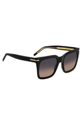 Gafas de sol de acetato negro con detalles metálicos dorados