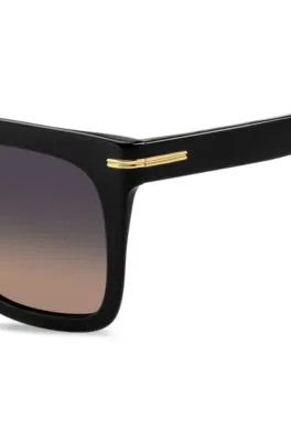 Gafas de sol de acetato negro con detalles metálicos dorados