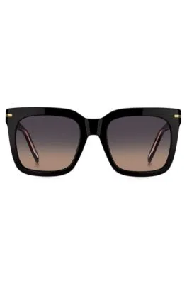 Gafas de sol de acetato negro con detalles metálicos dorados